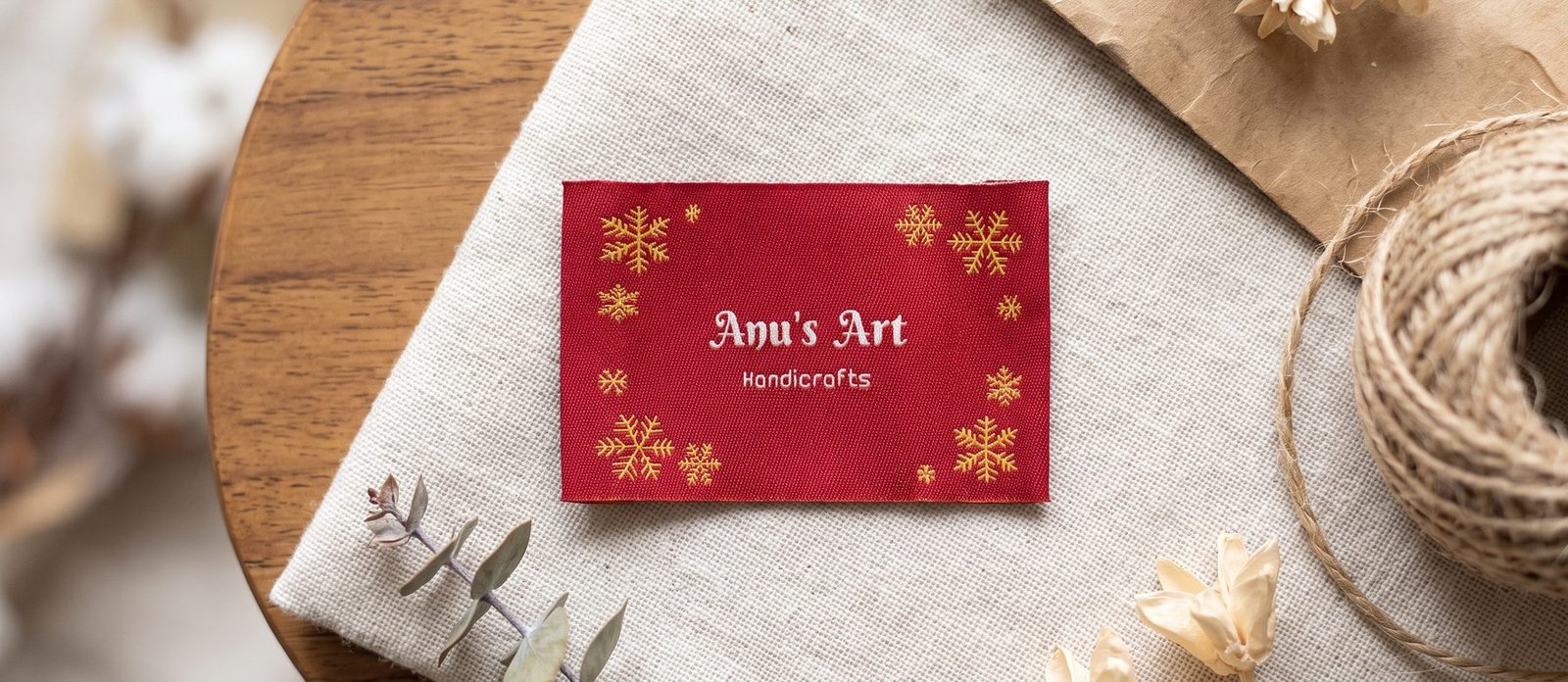 Woven red label reading Anu's Art, Handicrafts